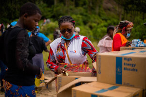 a WFP staff next to the food aid boxes